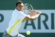 Jo-Wilfried Tsonga of France returns a shot to Milos Raonic 13 in Indian Wells, California, on March 13, 2013